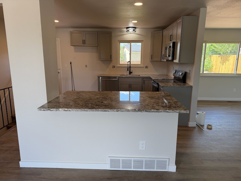Finished open kitchen and stone island by Yovani's Repair LLC